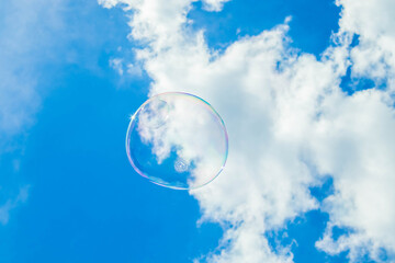 Big soap bubble against the blue sky.