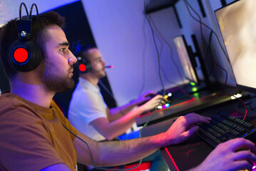 Fototapeta na wymiar Team of gamers playing computer games at night
