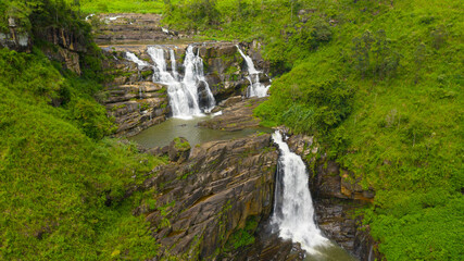 Fototapeta na wymiar Beautiful waterfall in the mountains and tea estate. St. Clair Falls, Sri Lanka.