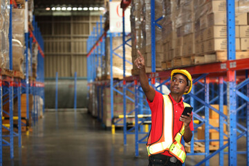  Portrait of worker in warehouse , they  happy and  working at The Warehouse. Storehouse area, Shipment.  warehouse worker unloading pallet goods in warehouse