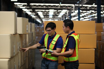  Portrait of worker in warehouse , they  happy and  working at The Warehouse. Storehouse area, Shipment.  warehouse worker unloading pallet goods in warehouse