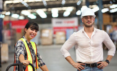 Portrait of worker in warehouse , they  happy and  working at The Warehouse. Storehouse area, Shipment.  warehouse worker unloading pallet goods in warehouse