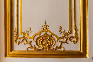 Fragment of the arch of a historic building with a golden base.