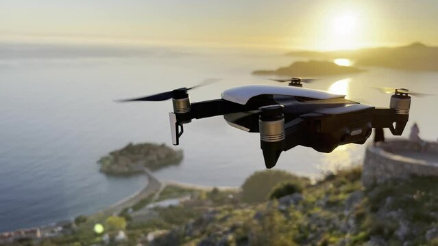 Four-engine drone filming the Sveti Stefan island at sunset in the sun