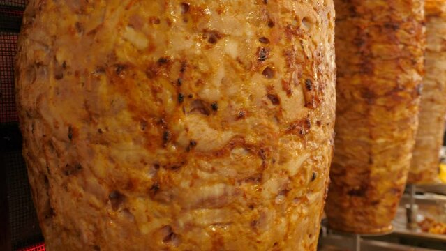 Traditional spinning spit of doner kebab meat in Turkish street snack bar