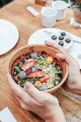 Acai smoothie bowls with strawberries, banana, blueberries, kiwi fruit and granola. Healthy Breakfast in summer.