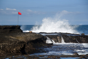 Fototapeta na wymiar Rock formation at the south area of Bali island,with black sand beach