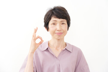 OKサインするシニア女性　白バック