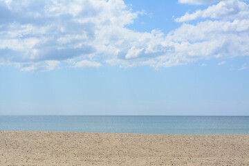 Picturesque view of sandy beach near calm sea on cloudy day