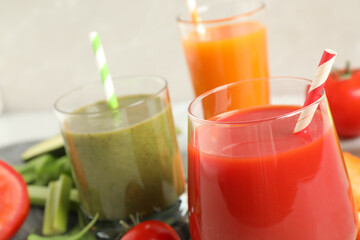 Delicious vegetable juices and fresh ingredients on table, closeup