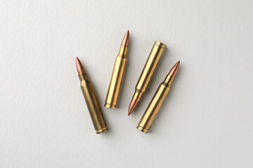 Brass bullets on white background, flat lay