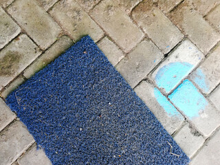 Blue palstic doormats placed on the floor