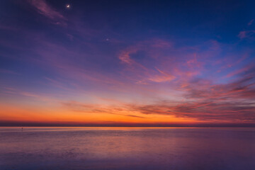 Fototapeta na wymiar sunset sky with dramatic sunset clouds over the sea. Beautiful sunrise over Ocean