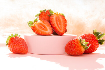 Ripe and red strawberries, halved, isolated, on a pedestal podium