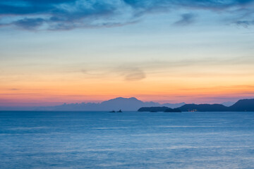 Obraz premium Sunset over the sea at the coast of Angra dos Reis town, State of Rio de Janeiro, Brazil. Photo taken with Nikon D7100, 18-200 lens, at 50mm, 5.0 sec f 11.0 ISO 100. Date: Dec 28, 2016