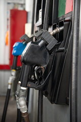Vertical image of gasoline and diesel fuel dispensing guns. Fuel station. Energy crisis