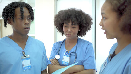 Group of American - African ethnicity medical student or intern doctor in general hospital making a...
