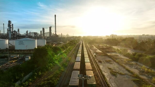 Freight train with Containers Cargos near Oil Refinery Plan back ground, Freight service forwarding and Logistics transportation Industry concept