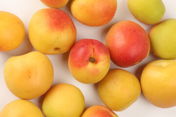 Fresh ripe juicy yellow orange red apricot fruit pile whole cut half slice seed on white background flat lay top view