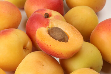 Fresh ripe juicy yellow orange red apricot fruit pile whole cut half slice seed on white background flat lay top view
