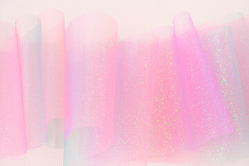 Tulle fabric.iridescent gradient texture.Shiny pink fabric with gradients. texture with iridescent...