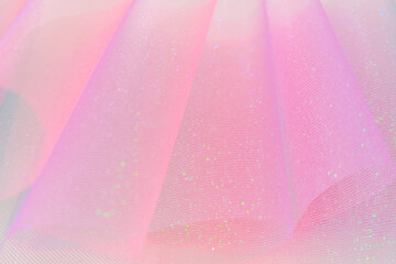 Fabric background.Wallpaper mauve phone.Tulle fabric.iridescent texture.Shiny pink fabric with...