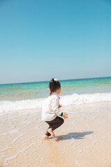 Fototapeta na wymiar a child playing on a surfy beach
