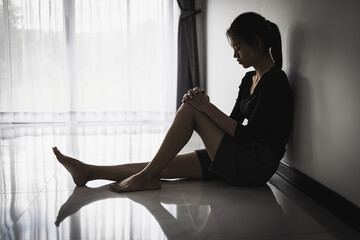 A woman sitting alone and depressed. The depression woman sit on the floor, human trafficking,...