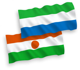 Obraz premium National vector fabric wave flags of Republic of the Niger and Sierra Leone isolated on white background. 1 to 2 proportion.