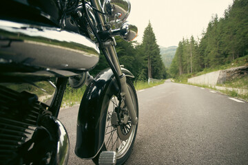 The front wheel of a motorcycle. Close up brakes and spokes