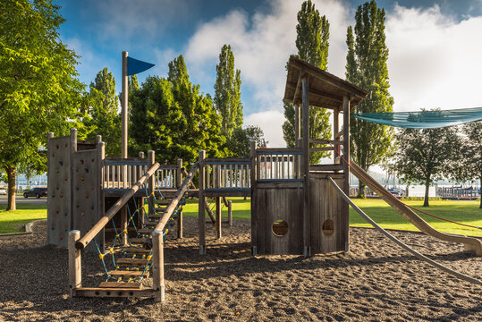 Empty outdoor playground with wooden equipment for children