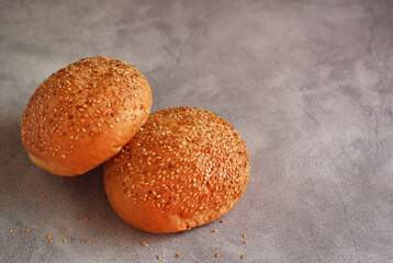 hamburger bun on a dark background under concrete with copy space