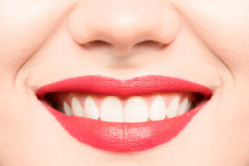 Fototapeta premium Beautiful female smile close up. Beautiful lip makeup, red lipstick.