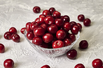 red ripe cherries in a glass cup on the table