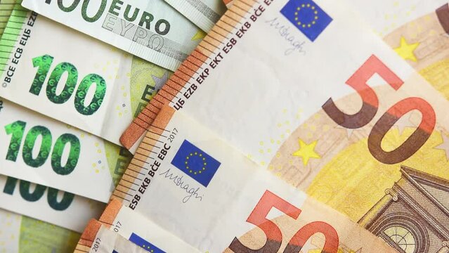Macro detail overlapping 50 and 100 euro banknotes, Euro currency panning slow motion 4K
