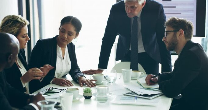 Group of diverse business people talking during a meeting in conference. Professional partners brainstorming, planning and discussing an idea or strategy. Focused colleagues consulting about startup
