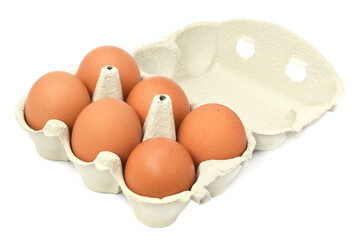 Six brown fresh raw chicken eggs in package or carton open isolated on white