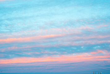 beautiful panorama of sky with pink clouds at sunset or sunrise. Light pink clouds in sunset blue...