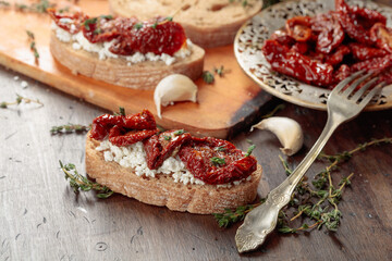 Bruschetta with ricotta, sun-dried tomatoes, and thyme.