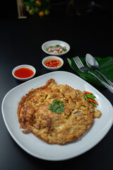 Minced pork omelette in white plate served with tomato sauce, fast food, high protein rental top view.
