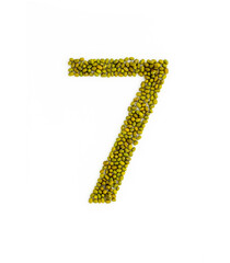 Number 7 made from mung beans. Green mung bean font. Alphabet made from green gram . White background. Dry green maash seeds.