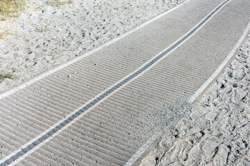 Roll-out beach mat or walkway over soft sand surface