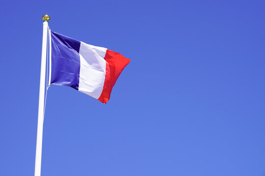 france flag french blue white red wave mat over a blue sky