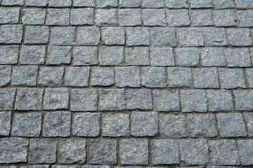 Road or foot path stone surface. Abstract texture for design. Rough stone surface. Traditional construction material