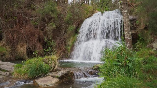 Establisher view of majestic natural waterfall Da Grova in Valen&ccedil;a do Minho, day