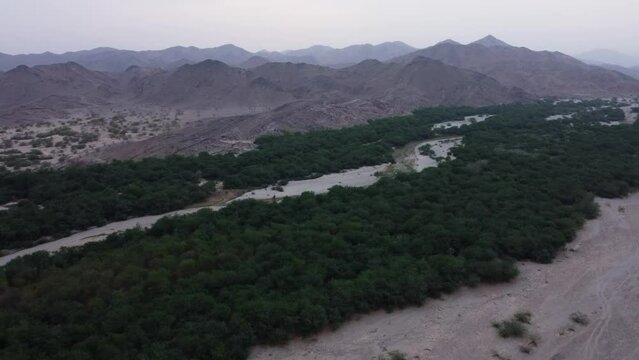 Al Lith hot spring landscape in cloudy day, Saudi Arabia. Aerial flying forward