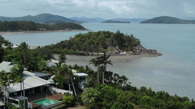 Waterfront luxury resort structure with swimming pool at Whitsundays islands in Australia. Aerial drone view