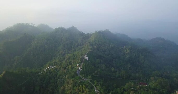 aerial drone view of rod on the top of Menoreh Hill, Magelang, Indonesia. 4K stock foggy jungle videos. tropical rain forest.