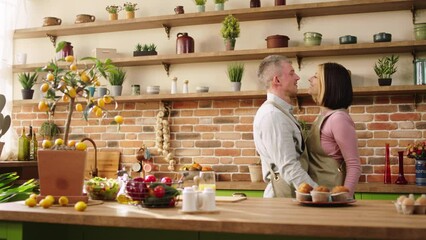Beautiful Caucasian couple very lovely dancing in the morning at the kitchen hugging each other with passion