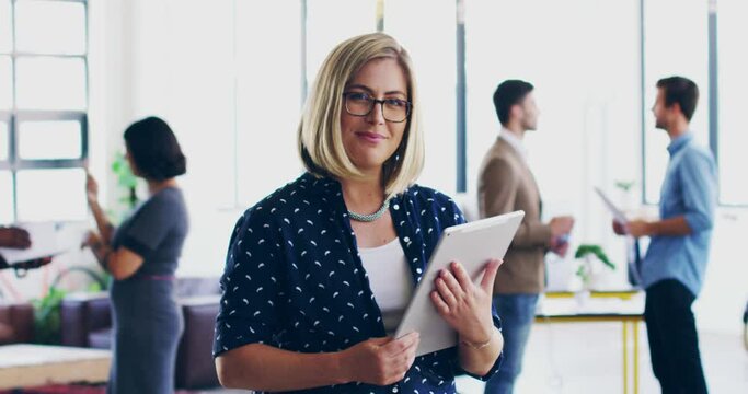 Confident successful accountant scrolling the internet on a handheld tablet in the office. Portrait of a happy female manager feeling proud and ready to lead a diverse team in a corporate office